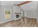 The living room is naturally lit and features a painted fireplace and wood beam at 2360 Highway 701 North, Loris, SC 29569