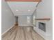 This home features an open living space with a fireplace, gray walls, and wood floors at 2360 Highway 701 North, Loris, SC 29569