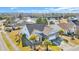 Aerial view of a home with a well-manicured lawn, a pond, and mature trees at 2385 Windmill Way, Myrtle Beach, SC 29579