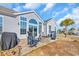 Relaxing backyard seating area with an outdoor fireplace and manicured lawn at 2385 Windmill Way, Myrtle Beach, SC 29579
