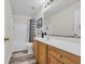Bathroom with a wooden vanity, large mirror, and shower-tub combination at 2385 Windmill Way, Myrtle Beach, SC 29579