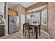 Charming breakfast nook featuring a bay window, stainless fridge, and tiled accent wall, creating a cozy dining experience at 2385 Windmill Way, Myrtle Beach, SC 29579