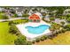 Aerial view of the kidney-shaped community pool with clubhouse and green landscaping at 2385 Windmill Way, Myrtle Beach, SC 29579