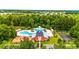 Aerial view of a community pool, clubhouse, playground, and basketball court at 2385 Windmill Way, Myrtle Beach, SC 29579