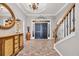 Grand Foyer with tile flooring, statement chandelier, and staircase at 2385 Windmill Way, Myrtle Beach, SC 29579