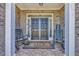 Inviting covered porch with double front doors, brick facade, and rocking chairs for relaxing at 2385 Windmill Way, Myrtle Beach, SC 29579