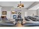 Spacious living room featuring a fireplace, TV, and a comfortable, oversized black leather sofa set at 2385 Windmill Way, Myrtle Beach, SC 29579