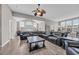 Expansive living room features leather furniture, vaulted ceilings, and abundant natural light, providing ample space for relaxation at 2385 Windmill Way, Myrtle Beach, SC 29579
