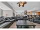 Open concept living room with a large sectional sofa and a view of the billiard room and kitchen at 2385 Windmill Way, Myrtle Beach, SC 29579