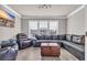 Comfortable living room features a large sectional sofa, a decorative wood chest, and ample natural light, creating a relaxing space at 2385 Windmill Way, Myrtle Beach, SC 29579