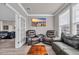 Cozy living room featuring leather seating, a wall-mounted TV, and an adjacent game room, perfect for relaxation and entertainment at 2385 Windmill Way, Myrtle Beach, SC 29579