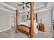 Spacious main bedroom with a decorative canopy bed, tray ceiling, and wood-look floors at 2385 Windmill Way, Myrtle Beach, SC 29579