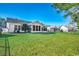 Expansive backyard showcasing a manicured lawn and the rear exterior of the homes at 2509 Oriole Dr., Murrells Inlet, SC 29576