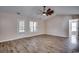 Living room featuring neutral walls, wood-look flooring, and a ceiling fan at 2509 Oriole Dr., Murrells Inlet, SC 29576