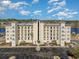 Stunning exterior view of a condominium featuring multiple balconies and ample parking space at 265 Venice Way # 1-201, Myrtle Beach, SC 29577