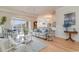 Open living area boasts natural light, hardwood floors, and a seamless flow to outdoor balcony at 265 Venice Way # 1-201, Myrtle Beach, SC 29577