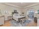 Relaxing bedroom with light colors, wood floors, tray ceiling and access to a balcony at 265 Venice Way # 1-201, Myrtle Beach, SC 29577