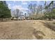 Exterior shot of a well-maintained single-Gathering home featuring a spacious yard and mature trees at 3281 Long Avenue Ext., Conway, SC 29526