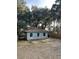 Charming home exterior with a gravel front yard, blue shutters, and mature trees at 335 Bayview Dr., Georgetown, SC 29440