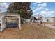 This backyard features a white swing, covered patio, and mature tree at 356 Boxcar Dr., Longs, SC 29568