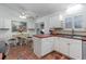 Bright kitchen with white cabinets, stainless steel appliances, and tile flooring at 356 Boxcar Dr., Longs, SC 29568