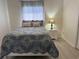 Comfortable bedroom featuring a bed with stylish blue bedding, pillows, and a nightstand with a lamp at 3700 Golf Colony Dr. # 26G, Little River, SC 29566