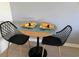 Cozy dining area with a round table, two modern chairs and a charming tablesetting for two at 3700 Golf Colony Dr. # 26G, Little River, SC 29566