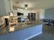 Open kitchen features stainless steel appliances, white cabinets, and a spacious island with granite countertops at 3700 Golf Colony Dr. # 26G, Little River, SC 29566