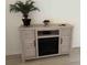 Stylish living room with a modern fireplace, TV console and decorative plant at 3700 Golf Colony Dr. # 26G, Little River, SC 29566