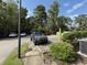 Well-maintained parking lot with ample parking spaces and mature trees creating a serene environment at 3700 Golf Colony Dr. # 26G, Little River, SC 29566
