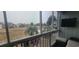 Relaxing screened-in porch with a scenic view of the community's lush green space, palm trees and pool area at 3700 Golf Colony Dr. # 26G, Little River, SC 29566
