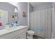 Bright bathroom featuring a shower and patterned shower curtain at 414 Antietam Place, Little River, SC 29566