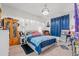 Bright bedroom with a crystal chandelier, a cozy sitting area, and a comfortable bed at 414 Antietam Place, Little River, SC 29566