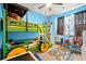 Fun bedroom with tractor-style bunk bed, ceiling fan and blue painted walls at 414 Antietam Place, Little River, SC 29566