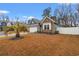 Charming single-story home featuring stone accents, blue siding, a two-car garage, and a well-manicured lawn at 414 Antietam Place, Little River, SC 29566