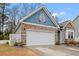 Spacious two car garage with stone and siding exterior is perfect for storing vehicles and more at 414 Antietam Place, Little River, SC 29566
