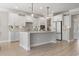 Bright, modern kitchen with a center island, stainless steel appliances, and custom white cabinetry at 482 Noah Ave., Myrtle Beach, SC 29579