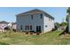 Backyard of a two-story home with a patio seating area and landscaped garden, perfect for outdoor relaxation at 5052 Riverton Ct, Myrtle Beach, SC 29579