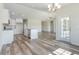 Open concept living space with modern lighting, kitchen island and view to yard at 621 Woodside Dr., Conway, SC 29526