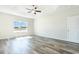 Main bedroom boasts tray ceilings, a ceiling fan, and a large window to bring in natural light at 621 Woodside Dr., Conway, SC 29526