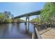 Scenic riverfront view showcasing a bridge and natural surroundings with lush greenery under a clear sky at 621 Woodside Dr., Conway, SC 29526