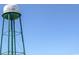 Captured low-angle perspective of a water tower set against a clear blue sky, showcasing simple and functional design at 621 Woodside Dr., Conway, SC 29526