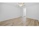 Spacious bedroom featuring laminate floors, a ceiling fan, neutral decor, and ample closet space at 650 Wilshire Ln., Murrells Inlet, SC 29576