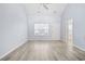 Bright living room boasting high ceilings, laminate floors, and lots of natural light from large front window at 650 Wilshire Ln., Murrells Inlet, SC 29576