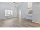 Open-concept living area with light-filled ambiance, a ceiling fan, and light wood floors at 650 Wilshire Ln., Murrells Inlet, SC 29576