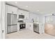 Modern kitchen with stainless steel appliances, white cabinets, and quartz countertops at 6606 Wildwood Trail # E, Myrtle Beach, SC 29572