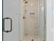 Close-up of glass shower with tile surround and bench at 6606 Wildwood Trail # E, Myrtle Beach, SC 29572