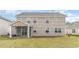 Spacious backyard view of the house highlighting a large yard with green grass, a screened porch, and the exterior at 7006 Shooting Star Way, Myrtle Beach, SC 29579