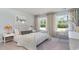 Bright bedroom featuring natural light, a comfy bed, and a cozy hanging chair; perfect for relaxation at 7006 Shooting Star Way, Myrtle Beach, SC 29579