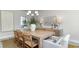 Bright dining room with a modern chandelier, large wooden table, and a sideboard at 7006 Shooting Star Way, Myrtle Beach, SC 29579